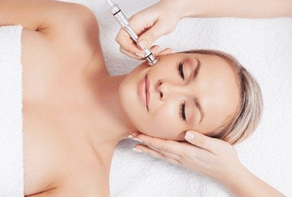 Woman receiving hydrodermabrasion treatment